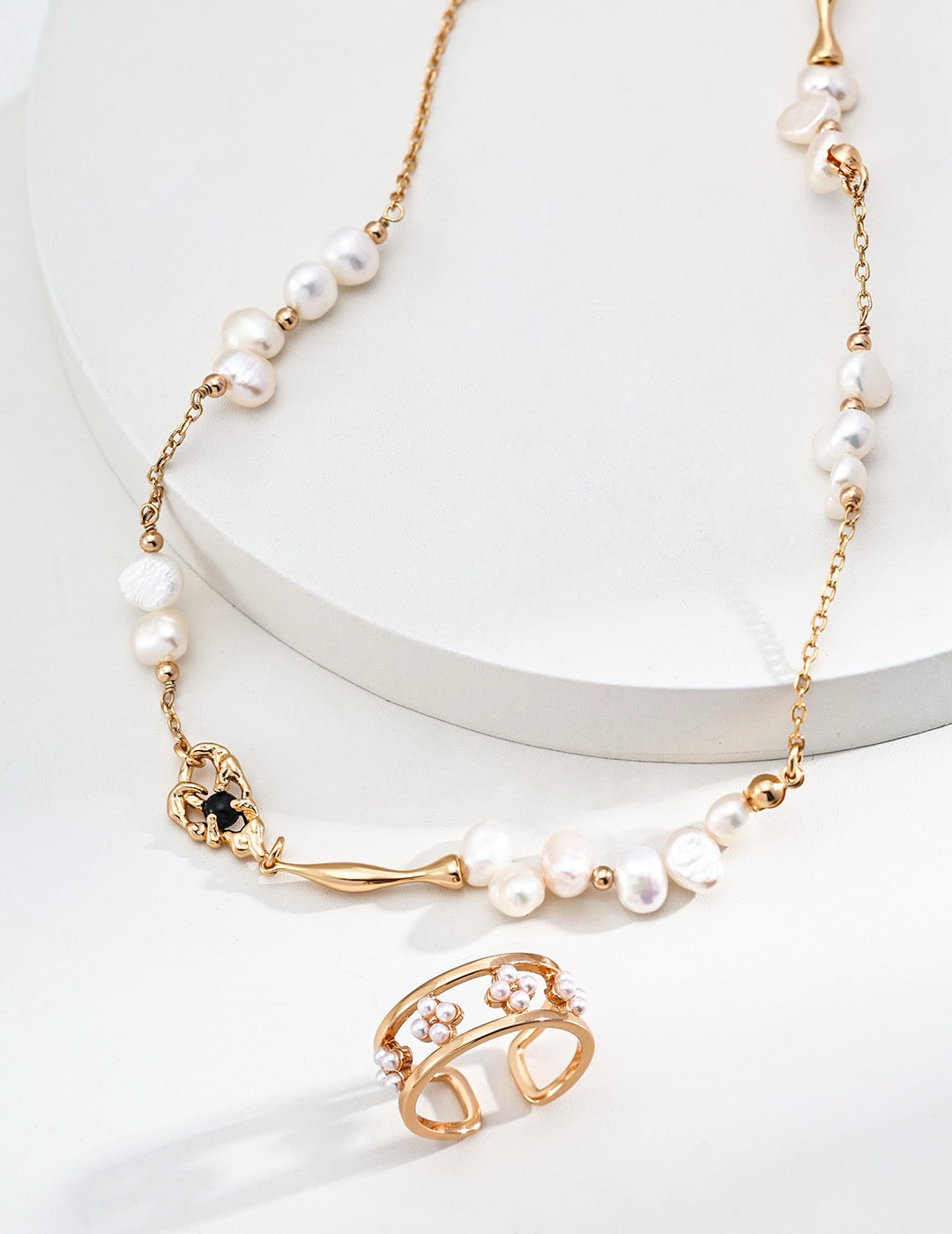 18K Gold open ring with a floral design and the 18K Gold freshwater pearl necklace displayed on a white background, a jewelry matching set.