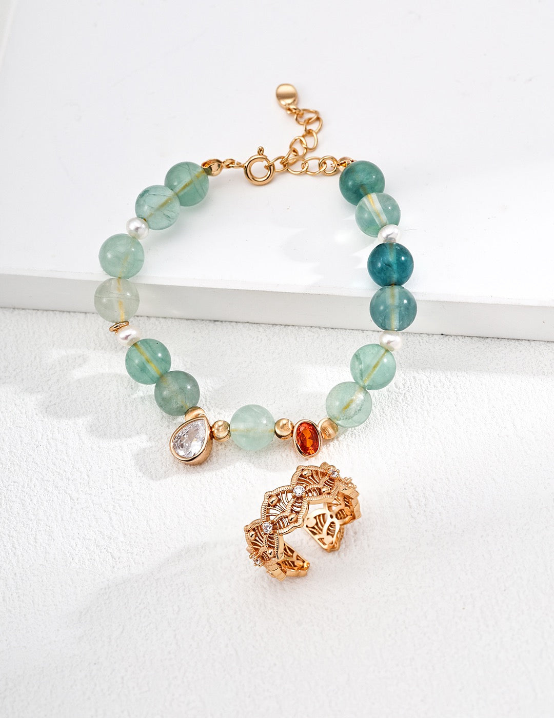 Bracelet with aquamarines and gold accents on a white background