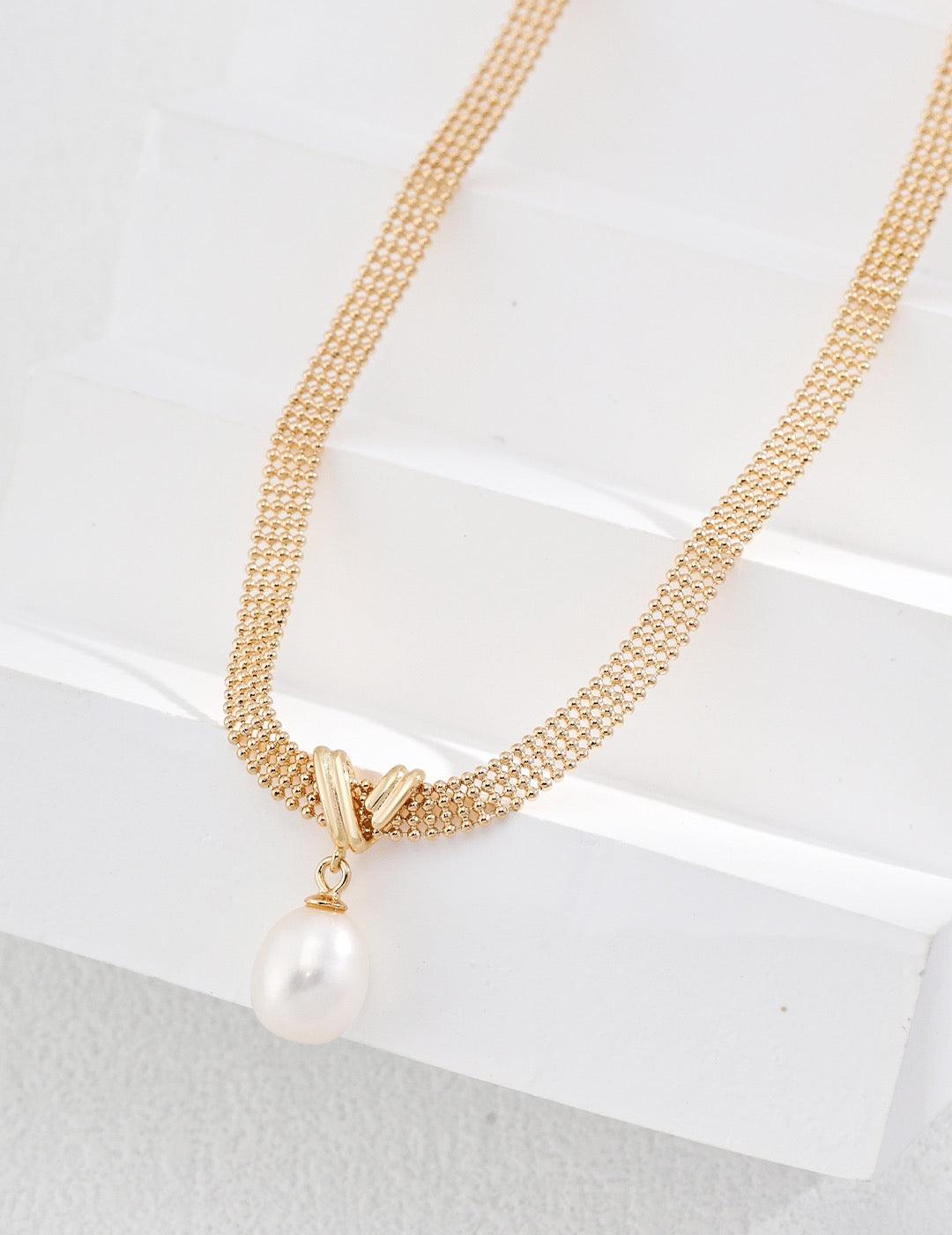 Aurelia Mesh Necklace displayed on the white stairs - Lia Atelier