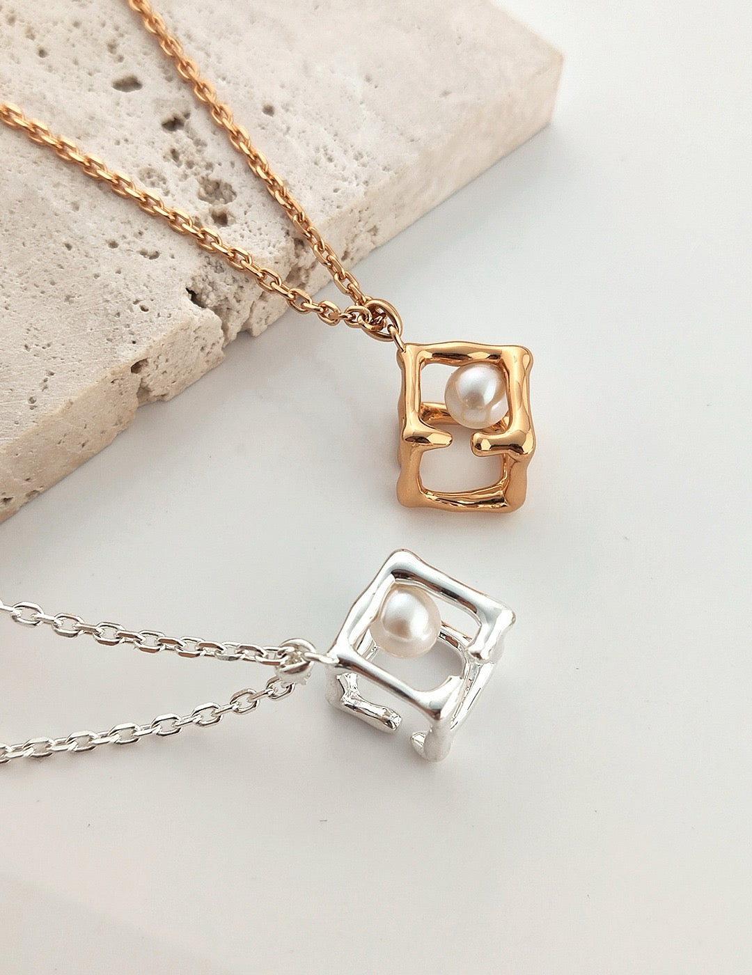 Aurora Cage Pearl Necklace featuring a freshwater pearl inside an abstract gold vermeil and silver cage design