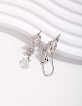 Sterling Silver butterfly asymmetrical earrings with opal and freshwater pearl on a white curve background
