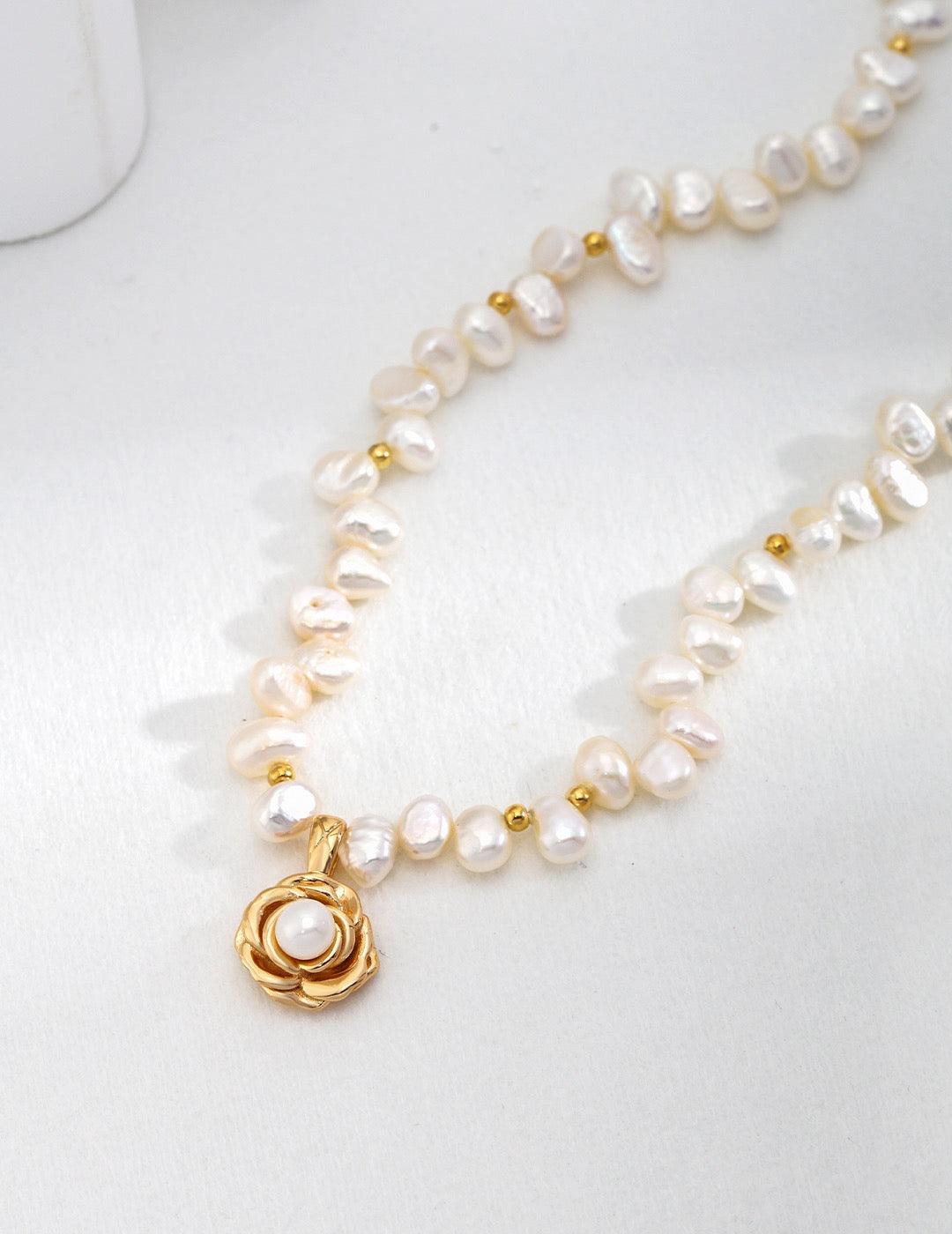 A close-up of Pearl Necklace with golden flower pendant