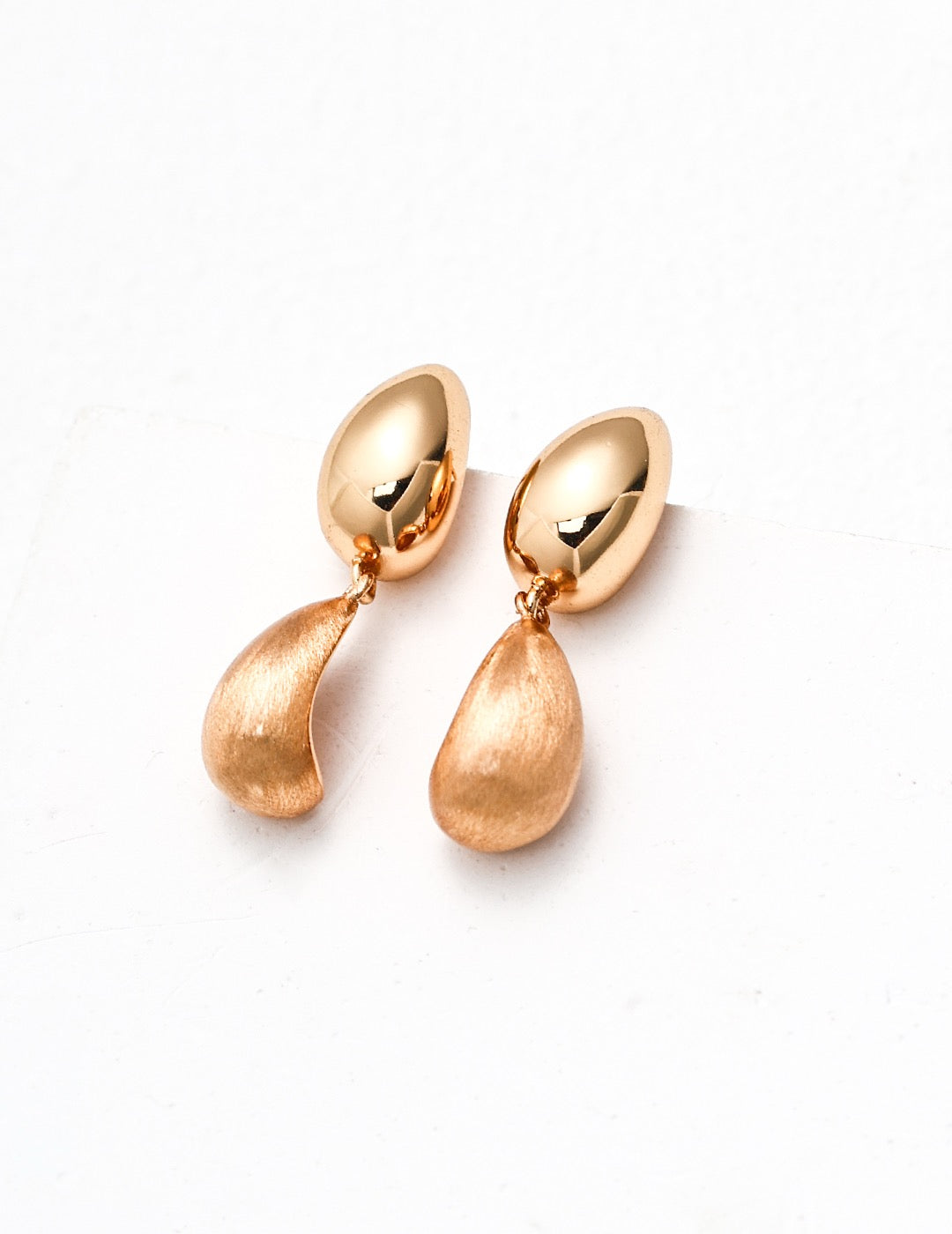 Pair of gold earrings on a white background