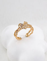 Adjustable gold open ring with crystal inlay for women.