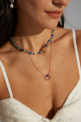 A women wear the Dahlia Lapis Lazuli  Necklace on a white dress
