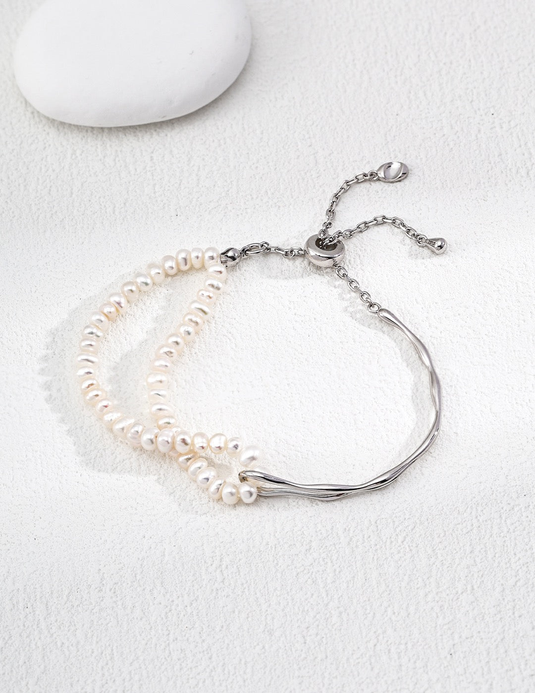 Dual chain Freshwater Pearl bracelet with a sterling silver clasp on a white background