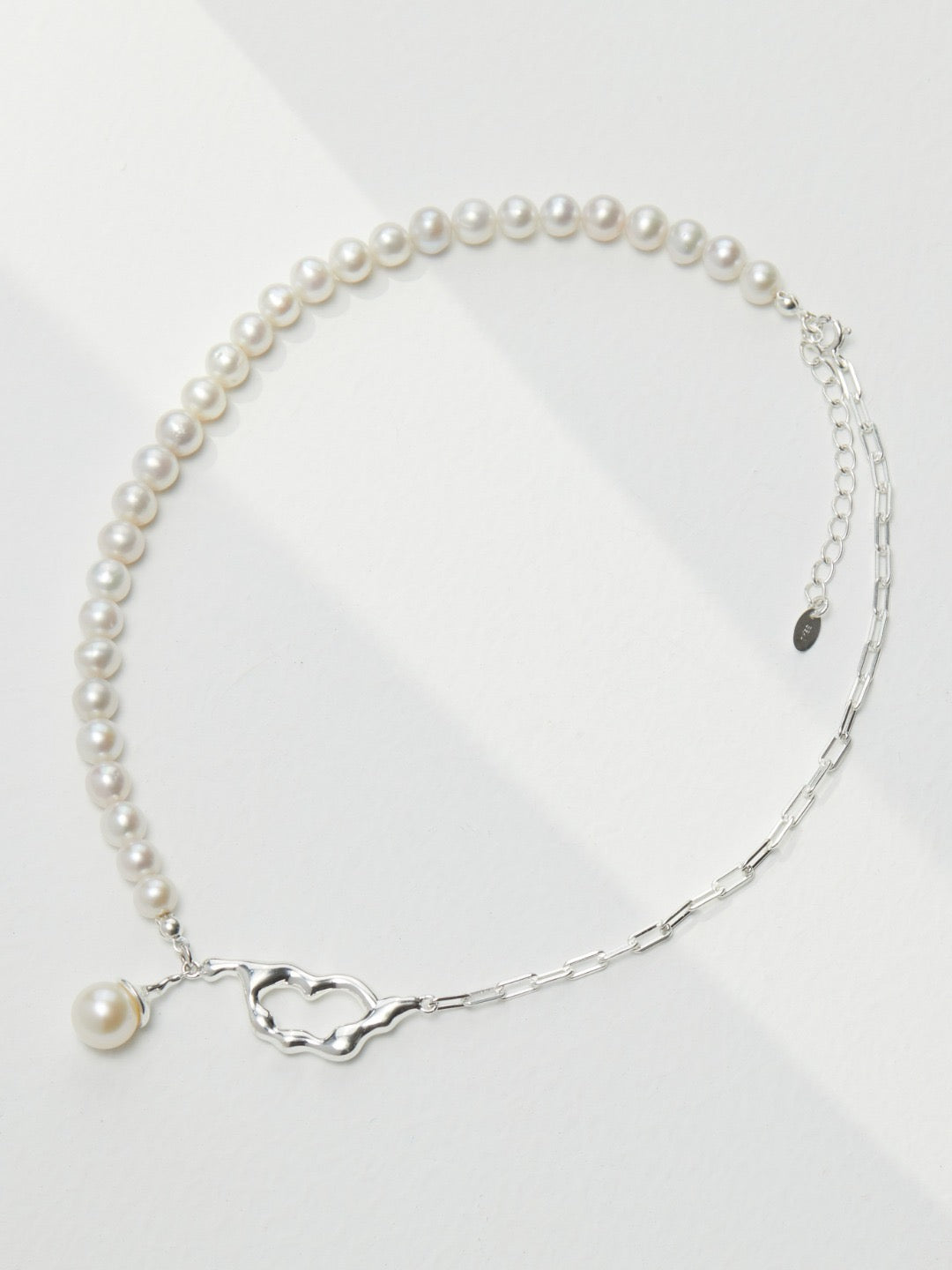 Elettra Asymmetrical Pearl Pendant displayed on the white background Necklace - Lia Atelier