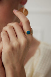 A person wearing a beige sweater with an 18K Gold Vermeil Enamel Open Ring on their finger.