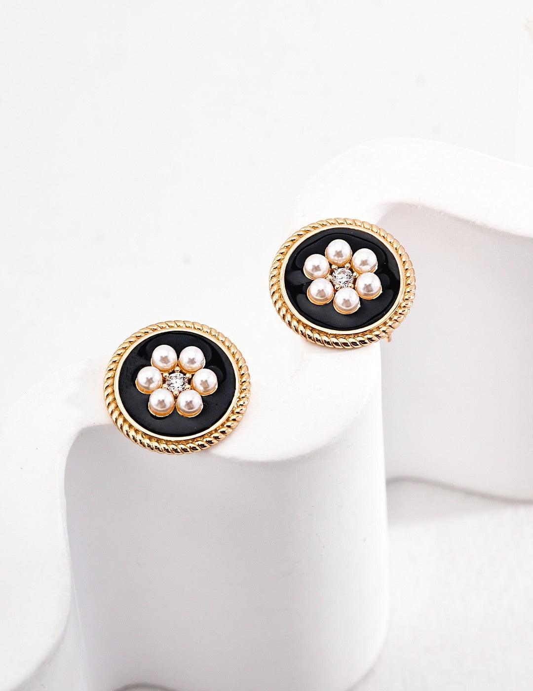 Genevieve Stud Earrings displayed on the white curve rock.