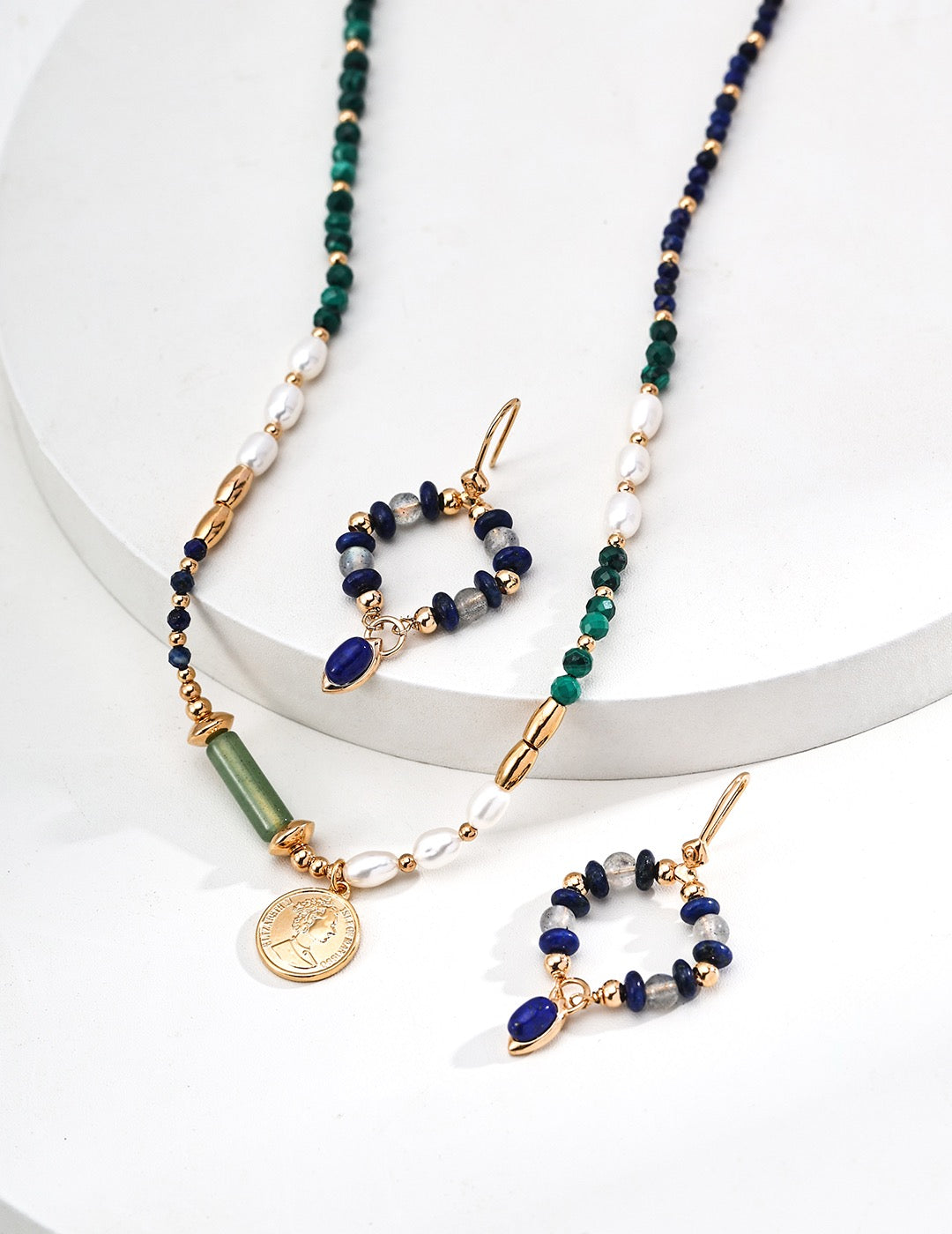 Set of beaded necklaces and earrings on a white background