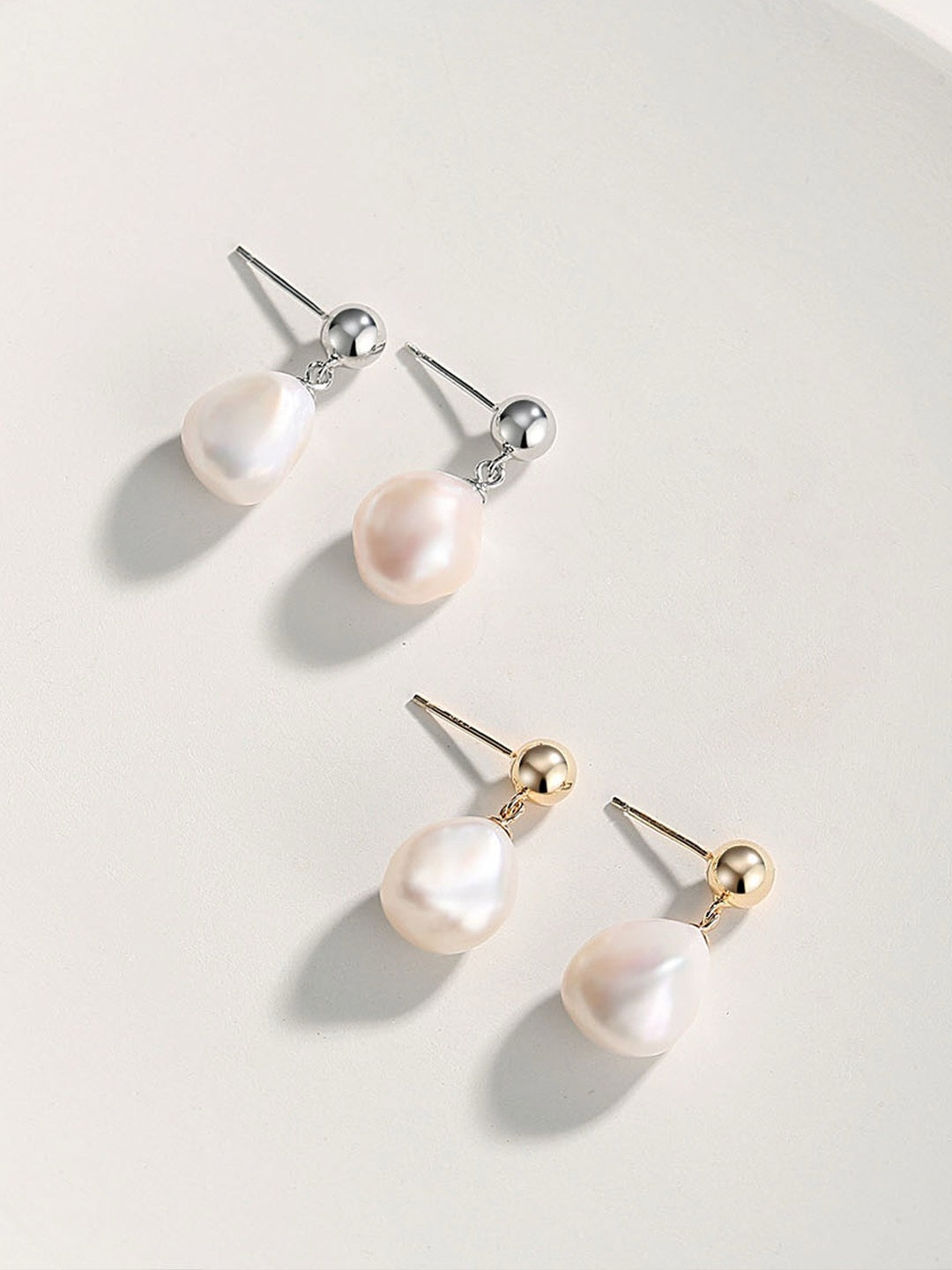 Isla Baroque Pearl Earrings featuring organic freshwater pearls with gold vermeil and sterling silver settings, displayed on a minimalist white background.