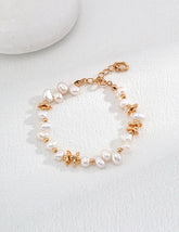 The Ivy Pearl Bracelet is displayed on a white background, showcasing the lustre of the pearls and the gold beads.