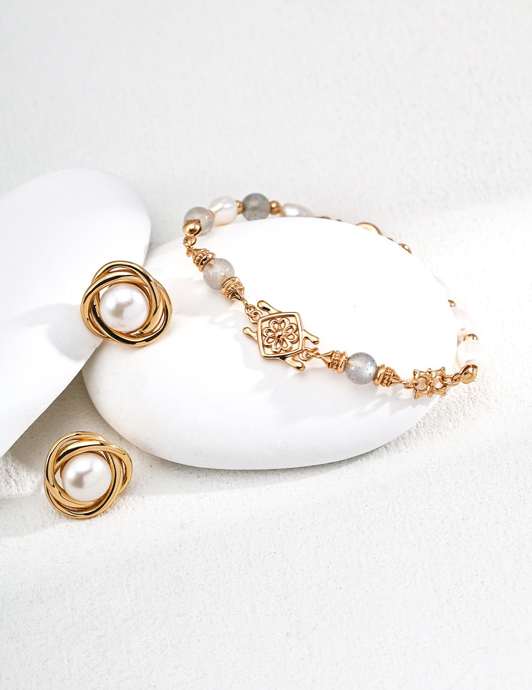 Gold Labradorite bracelet and earrings on a white stone