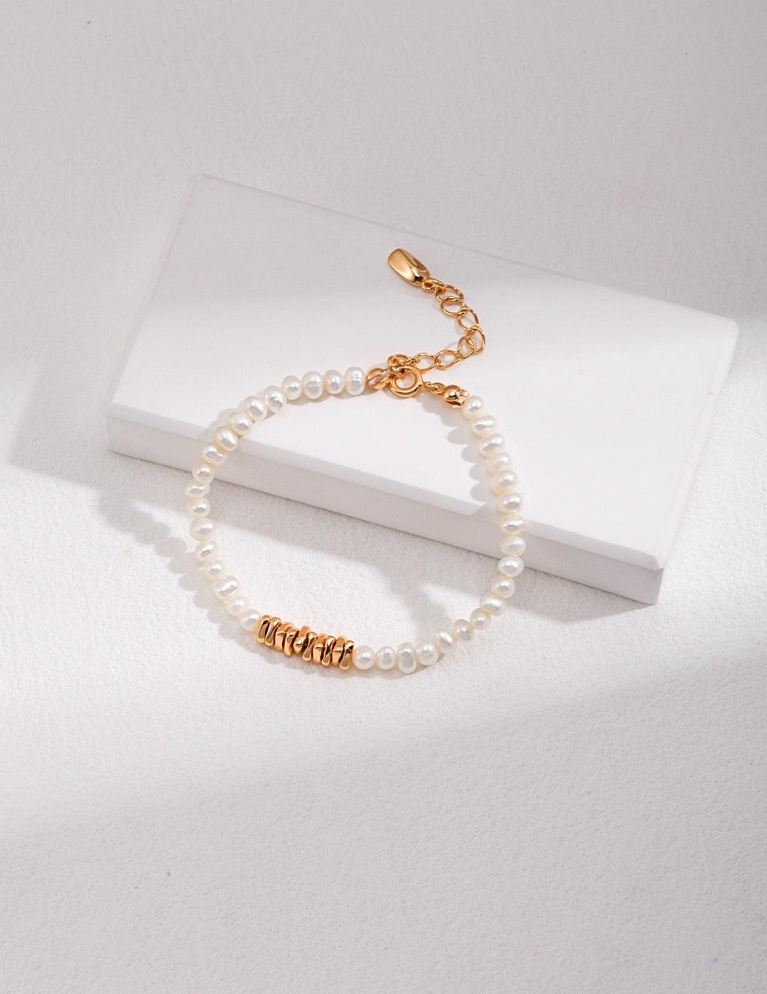Lorelei Pearl Bracelet, with 4-4.5mm freshwater pearls and 18K gold vermeil accent beads displayed on the white rock.
