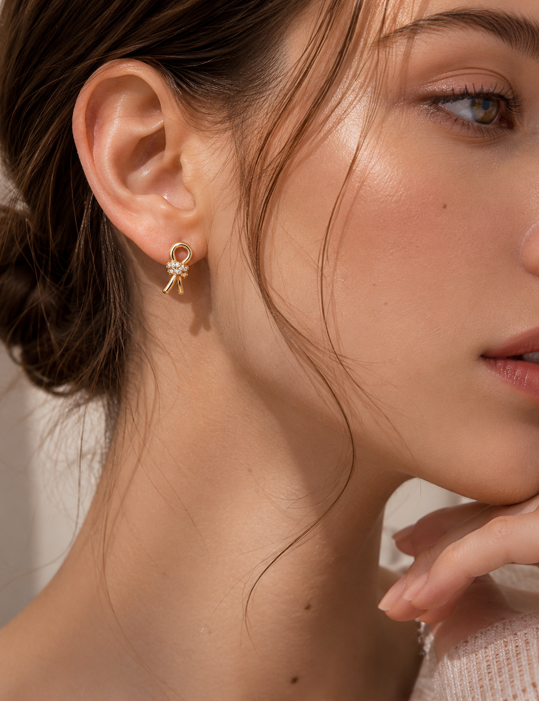 18K gold vermeil Lucette crystal bow stud earrings worn on a model