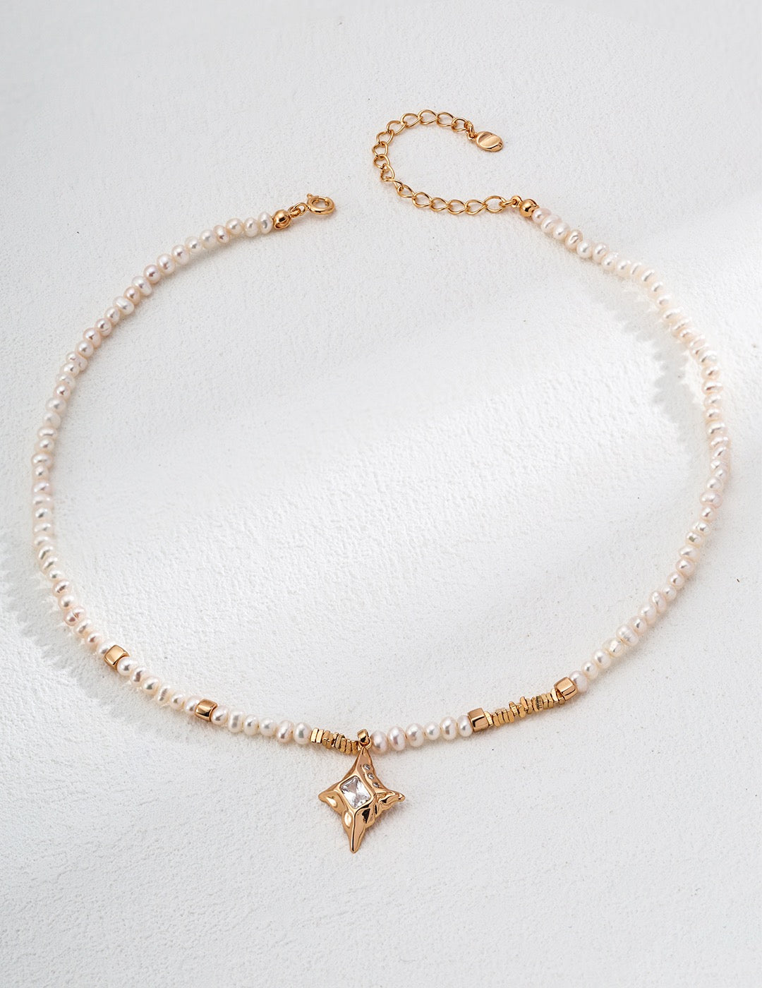 Pearl necklace with a star-shaped zircon pendant on a white background