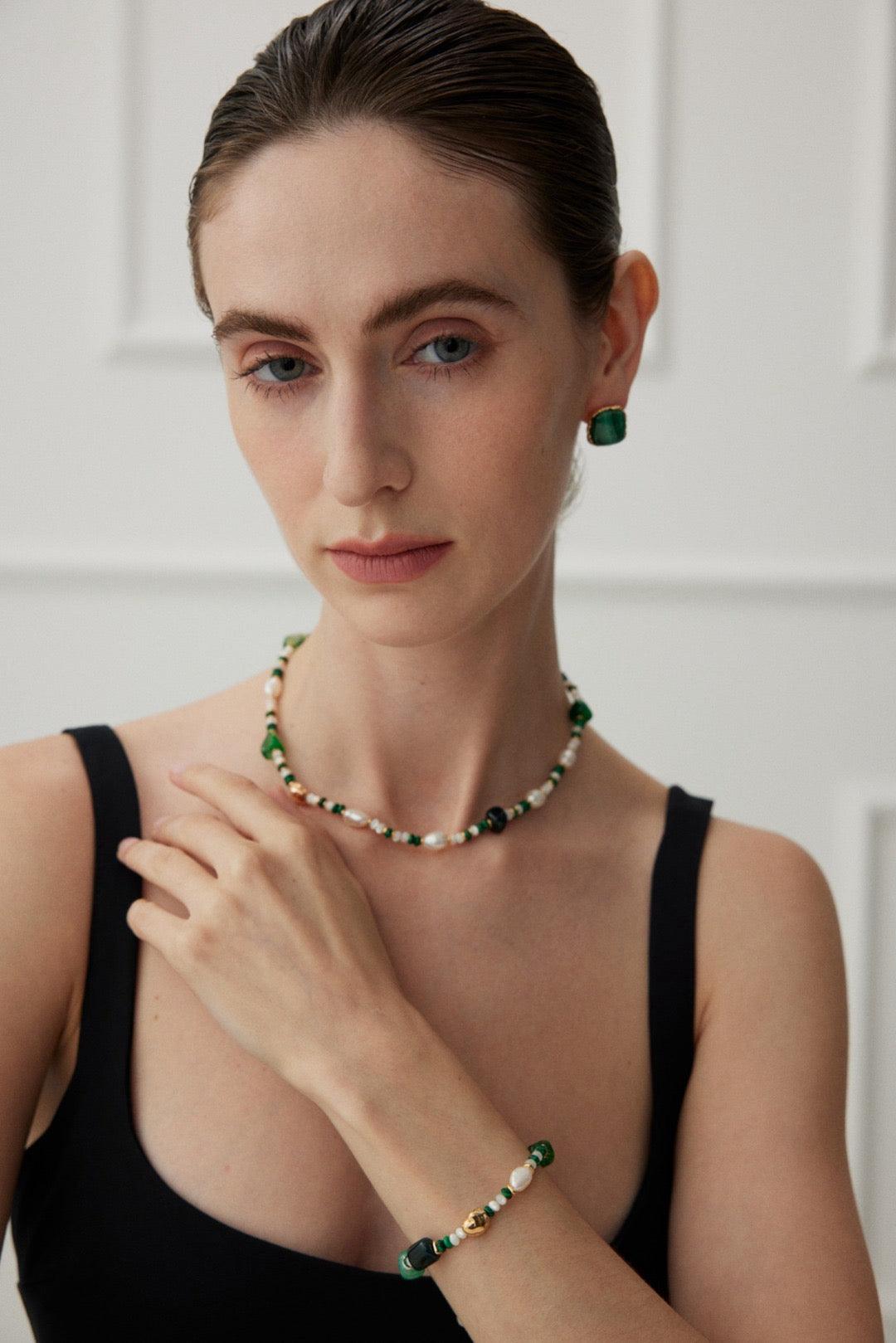 The model wears the Glimmer Agate & Malachite Necklace and a set bracelet.
