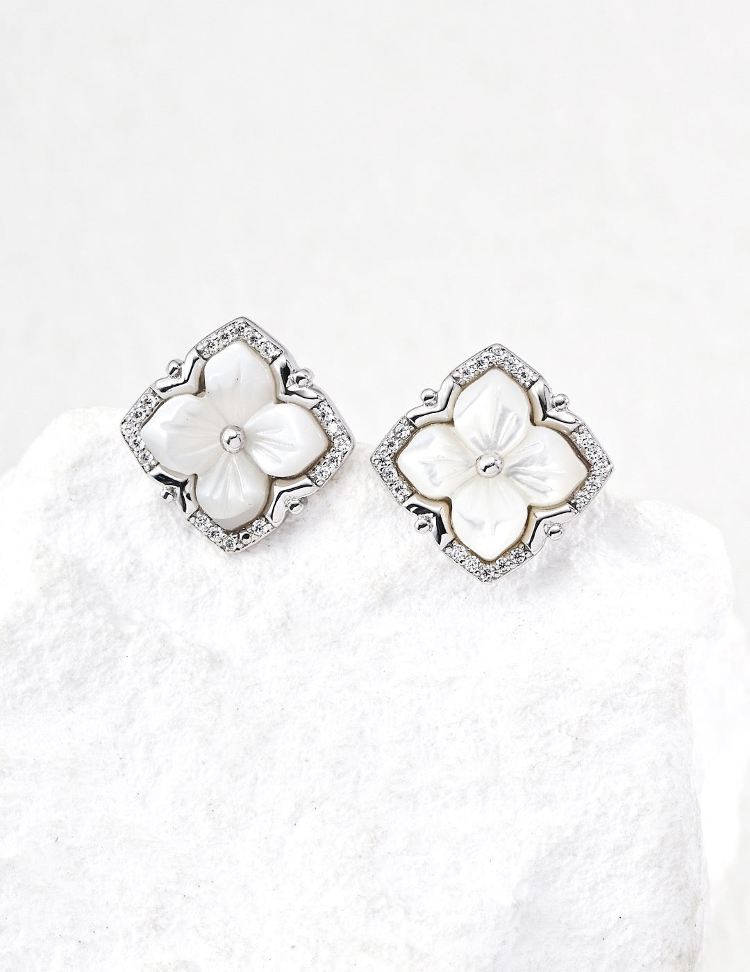close up of Mother of Pearl Clover Studs in sterling silver displayed on the white rock