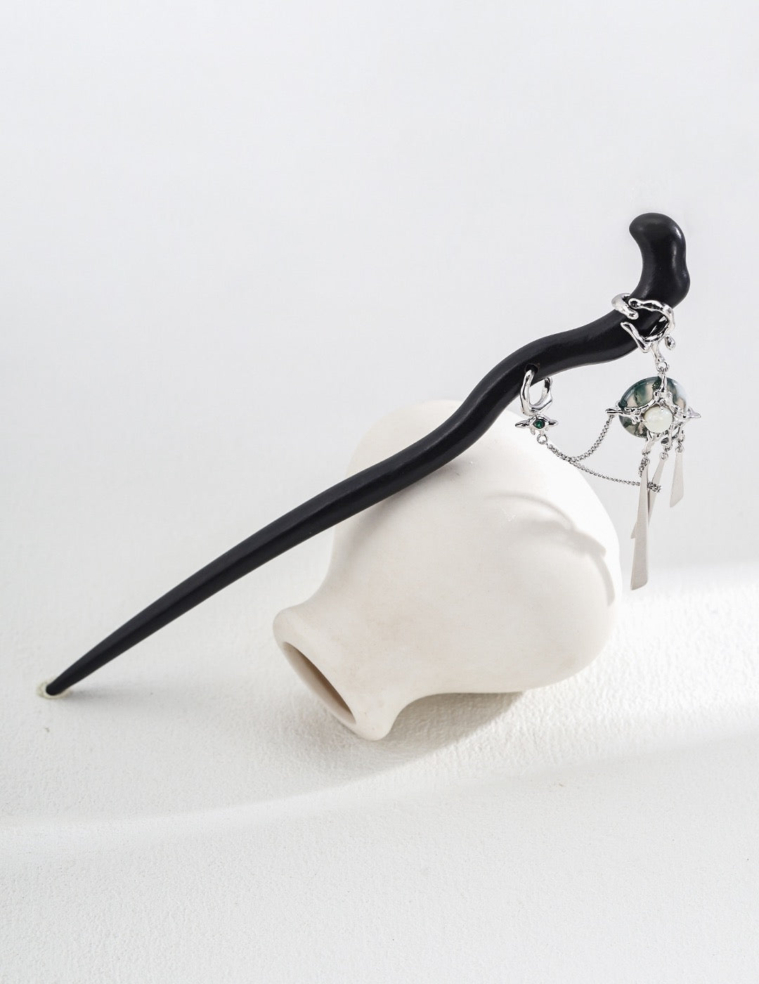 Close-up of moss agate, pearl and sterling silver hairpin details