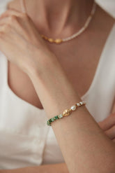 Pearl Shimmer Bracelet featuring Transvaal jade, baroque pearls, and mother-of-pearl with 18K gold vermeil accents wear by a woman.