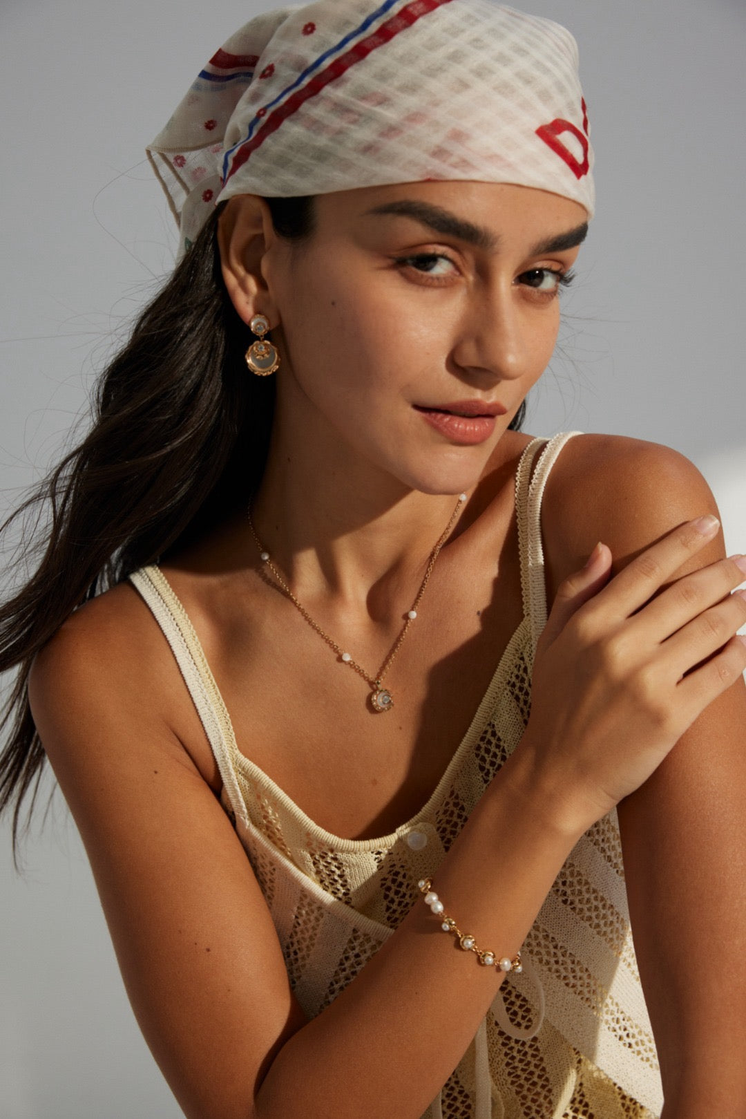 A women wear the Rayna Necklace Set on a knit tank top.