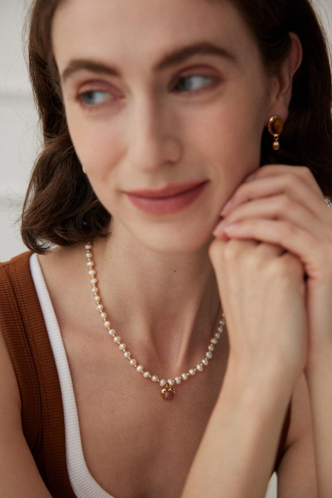 Side view of the Strawberry Quartz Pearl Necklace with gold accents.