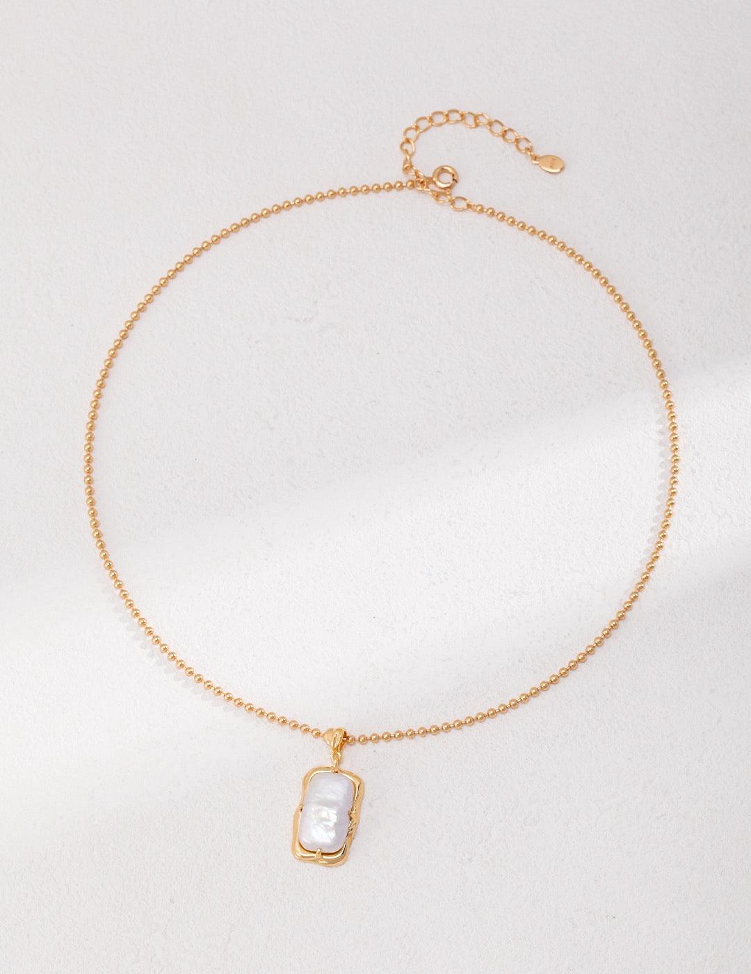 Top-down view of the Calista Freshwater Pearl Necklace In 18K Gold, showcasing pearl pendant. | Lia Atelier