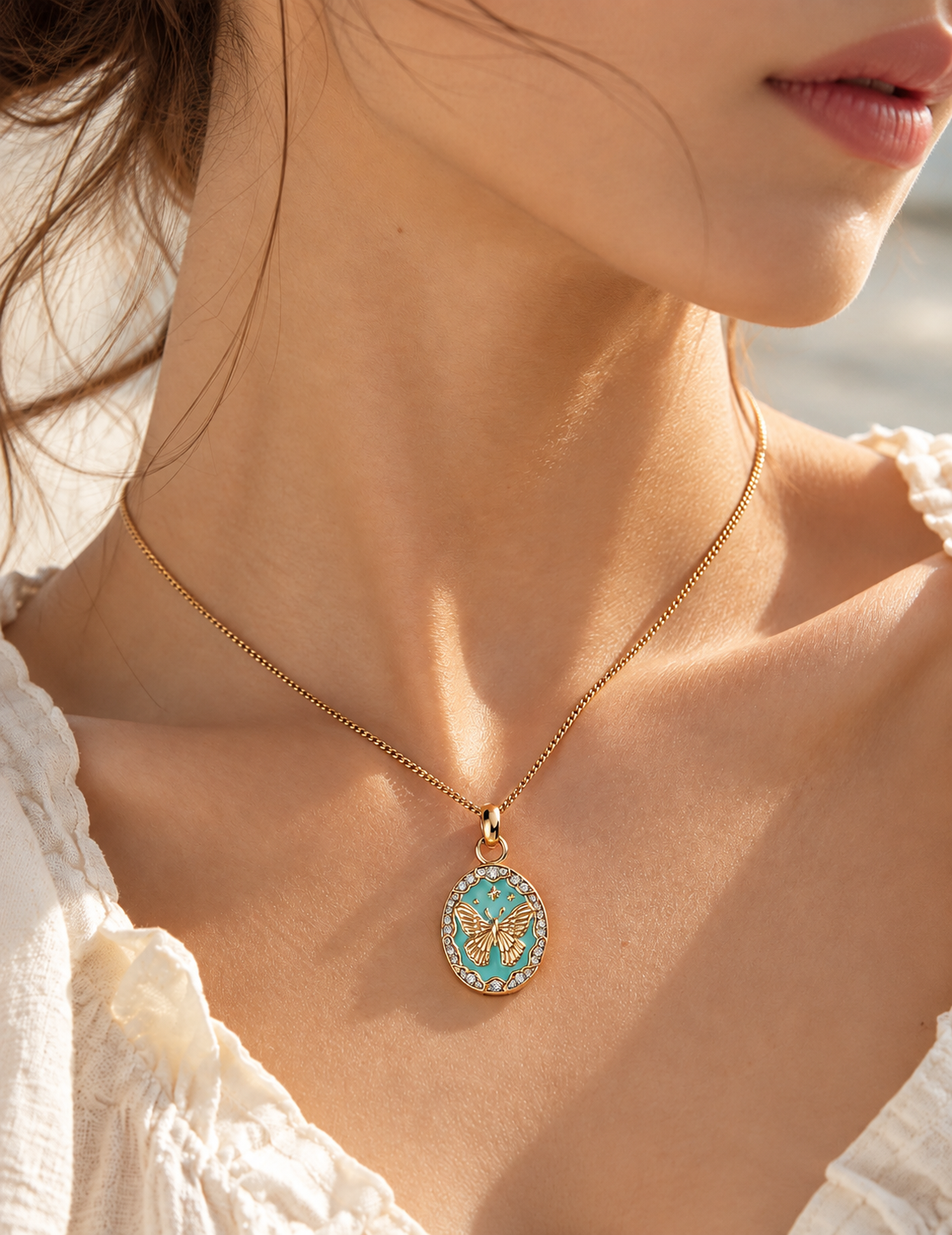 Whimsical Butterfly Enamel Medallion Necklace worn by a model, with a turquoise enamel pendant and gold butterfly detail