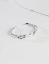 Silver bracelet with small pearls on a light gray background