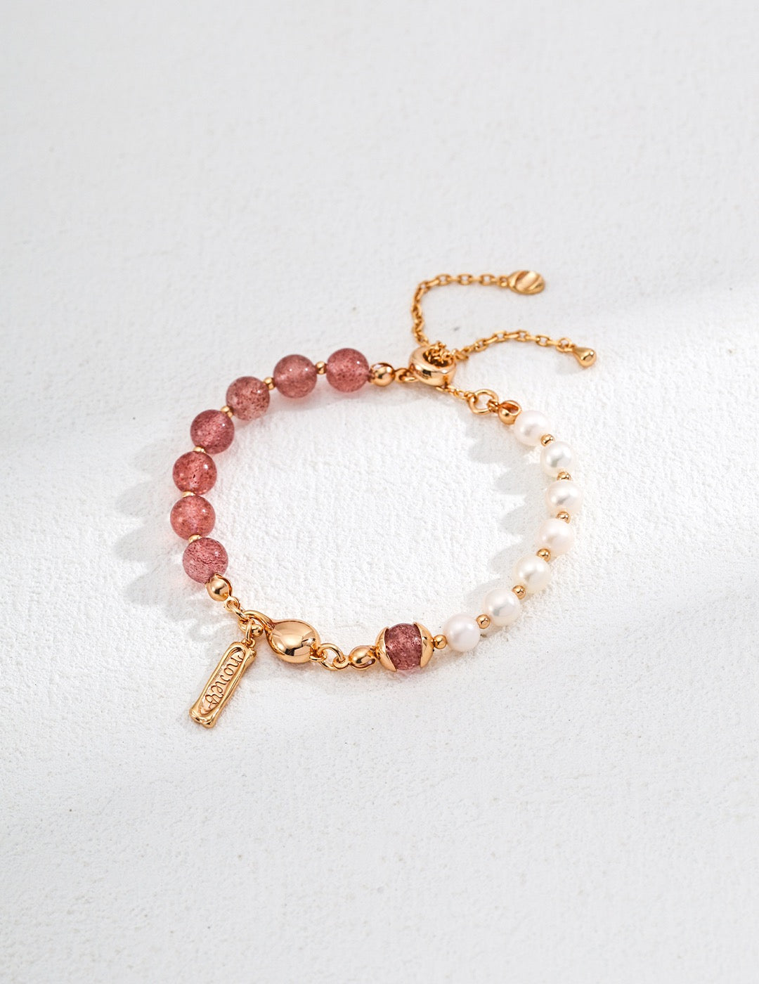 18K gold vermeil bracelet with vibrant strawberry quartz beads and freshwater pearls, detailed with a gold heart charm and engraved tag on an adjustable chain.