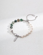 Sterling silver bracelet featuring alternating ocean agate beads and freshwater pearls, accented with a polished heart charm and dainty tag on a delicate chain.