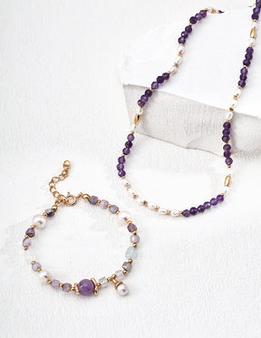 Beaded necklace with purple and gold beads on a white background