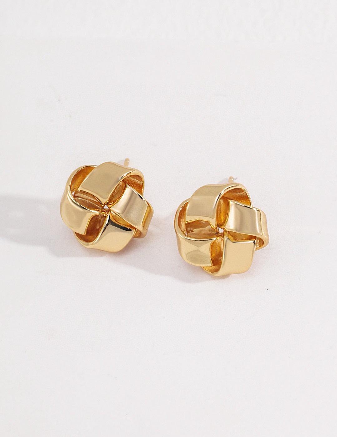 Anissa Gold Knot Earrings displayed on the white background