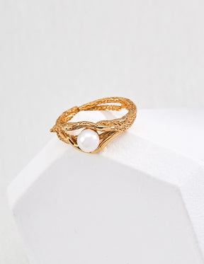 Gold ring with a 5mm pearl on a white background