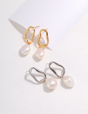 Aurora Baroque Pearl Drop Earrings feature naturally irregular 12-14mm baroque pearls suspended from fluid, sculptural hoops in luxurious 18K gold vermeil or sterling silver displayed on the white background. 