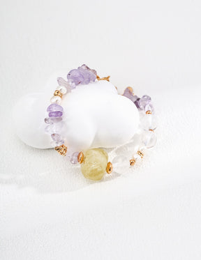 Bracelet with amethyst, citrine, rose quartz, and freshwater pearls on a white background