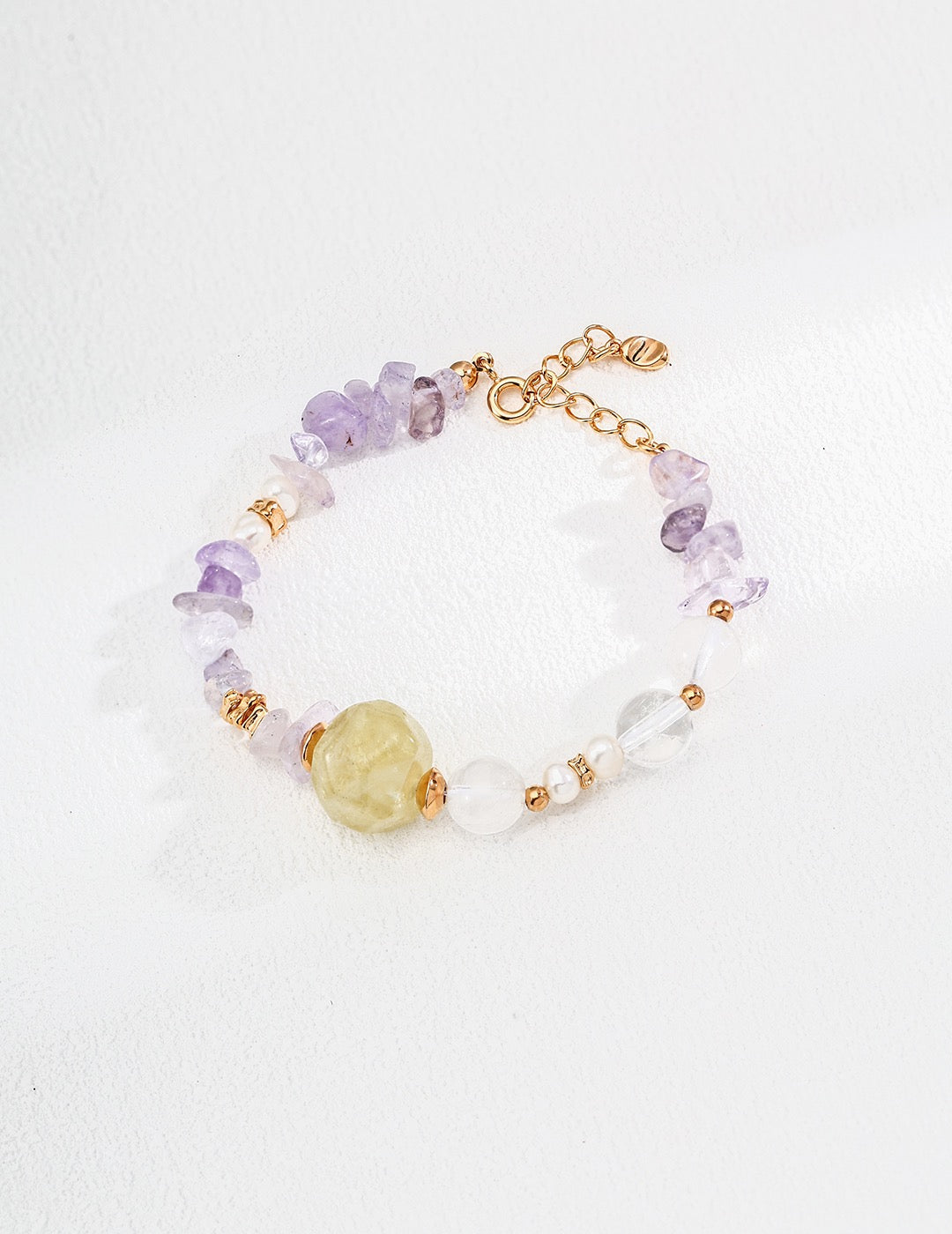 Bracelet with multicolored gemstones and gold accents on a white background