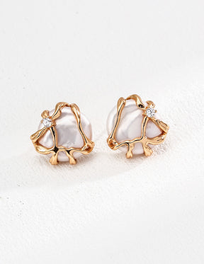 A pair of baroque pearl earrings with gold frames and zircon accents, displayed against a white background.
