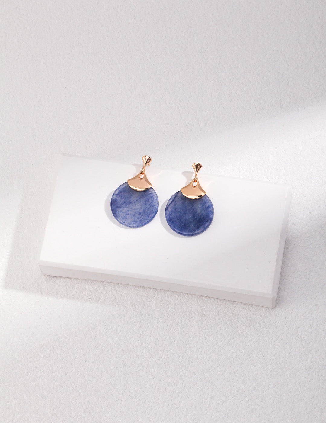 Pair of Blue Aventurine teardrop earrings with rose gold hooks on a white box.
