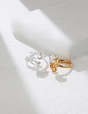 Close-up of Celestia Drip Ring in gold and silver, featuring a luminous opalite stone in a fluid, organic band design.