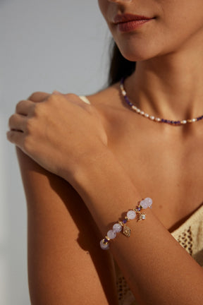 Model wearing the Celestial Amethyst Zircon Bracelet in 18K Gold, styled with a bohemian outfit for an elegant look.