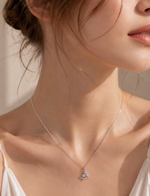 Sterling silver Celestine crescent moon and star necklace worn on a model