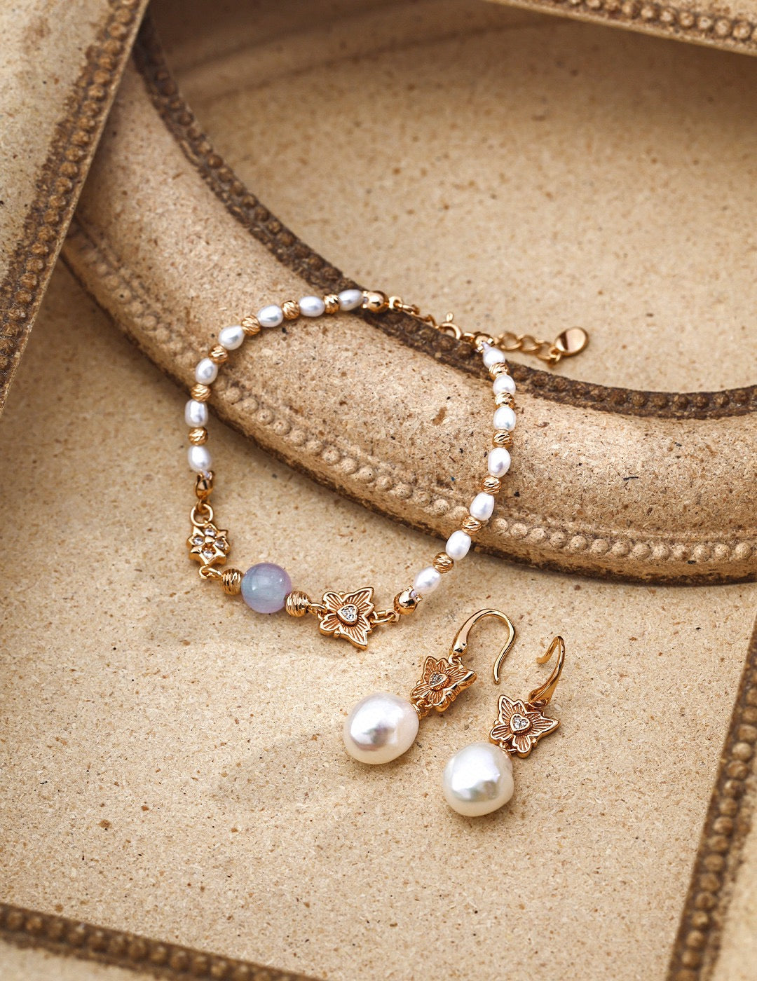 Close-up of 7mm chrysoberyl stones alternating with 4mm freshwater pearls on charm bracelet