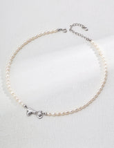 Freshwater pearl necklace with sterling silver bow pendant on gray background