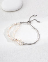 Dual chain Freshwater Pearl bracelet with a sterling silver clasp on a white background