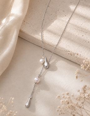 Sterling silver adjustable pearl lariat necklace displayed on a neutral background