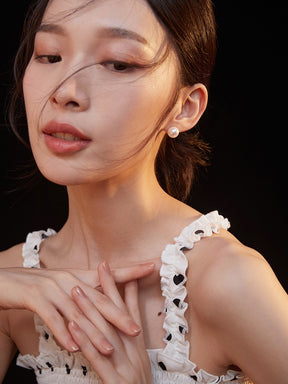 Woman wearing a white lace top with a blurred background