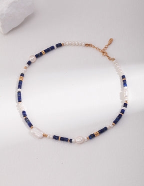 Necklace with blue and gold beads on a white background