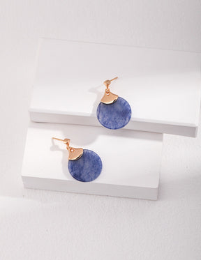 Pair of Blue Aventurine drop earrings with gold accents on a white surface