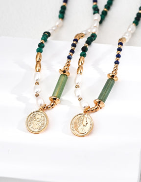 Necklace with gold coins, green and blue beads on a white background